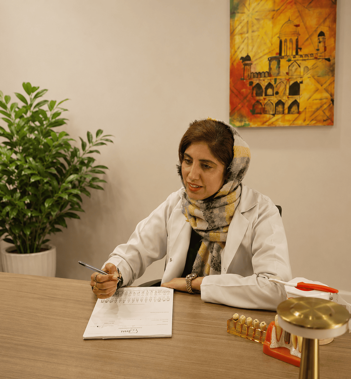 Aligner specialist reviewing a patient's dental chart and models during consultation